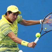 MELBOURNE, AUSTRALIA - JANUARY 18: Akira Santillan of Australia plays a backhand in his first round junior boys' match against Ken Onish of Japan during the 2014 Australian Open Junior Championships at Melbourne Park on January 18, 2014 in Melbourne, Australia.  (Photo by Matt King/Getty Images)
