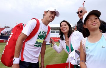Alex de Minaur of Australia poses for a photo with fans at The Queen's Club in London, England. [Photo: Annabel Lee-Ellis/Getty Images]