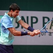 Australia's Alexei Popyrin plays a backhand return to Japan's Yoshihito Nishioka during their men's singles match on day 2 of the French Open tennis tournament at the Roland-Garros Complex in Paris on May 26, 2025. (Photo by Alain JOCARD / AFP) (Photo by ALAIN JOCARD/AFP via Getty Images)