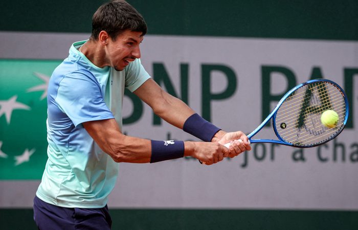 Australia's Alexei Popyrin plays a backhand return to Japan's Yoshihito Nishioka during their men's singles match on day 2 of the French Open tennis tournament at the Roland-Garros Complex in Paris on May 26, 2025. (Photo by Alain JOCARD / AFP) (Photo by ALAIN JOCARD/AFP via Getty Images)