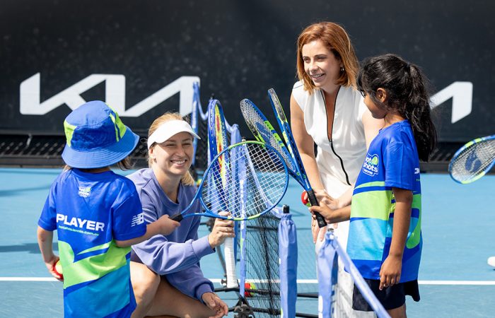 Anika Wells and Daria Saville with young female tennis players.