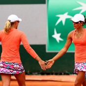 Anastasia Rodionova (L) and Arina Rodionova in doubles action at Roland Garros 2015; Getty Images