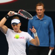 Sam Stosur plays a forehand as her coach David Taylor looks on during a practice session ahead of Australian Open 2013 at Melbourne Park; Getty Images
