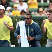 (L-R) Matt Reid, Nick Kyrgios and Alex De Minaur cheer from the sidelines during Australia's Davis Cup World Group first-round win over the Czech Republic at Kooyong; Getty Images