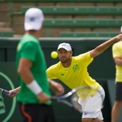 Hitting partner Matt Reid in action as Lleyton Hewitt watches on; Elizabeth Xue Bai
