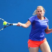 Jelena Dokic of Australia plays a forehand in her first round women's doubles match with Storm Sanders of Australia against Magdalena Rybarikova of Slovakia and Stefanie Voegele of Switzerland during day three of the 2014 Australian Open at Melbourne Park on January 15, 2014 in Melbourne, Australia.  (Photo by Renee McKay/Getty Images)