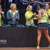 Casey Dellacqua shakes hands with Australian coach Nicole Pratt after winning the second singles rubber of the Netherlands v Australia Fed Cup World Group Play-off tie in 's-Hertogenbosch; Henk Koster