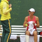 Sam Stosur (R) chats to Australian Fed Cup coach Nicole Bradtke during her match against Romina Oprandi; Getty Images