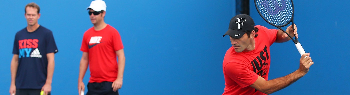 Roger Federer practices while Stefan Edberg (left) and Severin Luthi watch from the sidelines, Australian Open, Melbourne, 2014. GETTY IMAGES