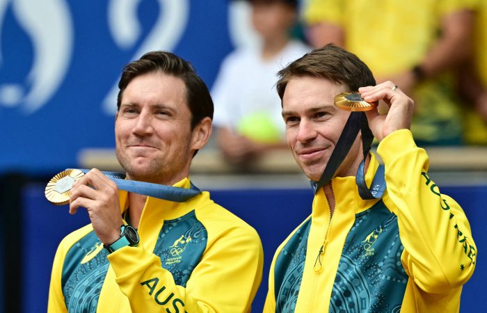 Gold medallists, Australia's Matthew Ebden (L) and Australia's John Peers (R) pose with their medals on the podium at the presentation ceremony for the men's doubles tennis event on Court Philippe-Chatrier at the Roland-Garros Stadium during the Paris 2024 Olympic Games, in Paris on August 3, 2024. (Photo by Miguel MEDINA / AFP) (Photo by MIGUEL MEDINA/AFP via Getty Images)