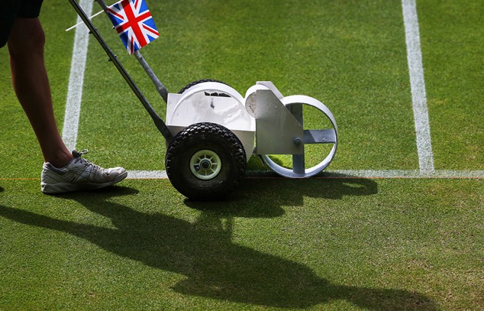 A groundsman paints the white lines on the grass of Centre Court at the Wimbledon Lawn Tennis Championships on July 1, 2013 in London, England; Peter Macdiarmid/Getty Images