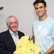 Ken Rosewall presents Aleksandar Vukic with his Australian Davis Cup team jacket.