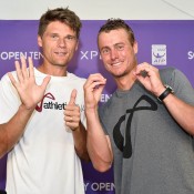 Lleyton Hewitt (R) and former Australian pro Peter Luczak celebrate Hewitt's 600th career victory following his first round defeat of Robin Haase at the Sony Open in Miami; Peter Staples/Sony Open Tennis