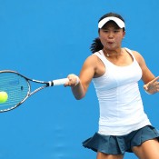 MELBOURNE, AUSTRALIA - JANUARY 19: Olivia Tjandramulia of Australia plays a forehand in her first round junior girls' match against Nozomi Ohya of Japan during the 2014 Australian Open Junior Championships at Melbourne Park on January 19, 2014 in Melbourne, Australia.  (Photo by Robert Prezioso/Getty Images)