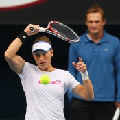 Samantha Stosur of Australia plays a forehand as her coach David Taylor looks on during a practice session ahead of the 2013 Australian Open at Melbourne Park on January 13, 2013 in Melbourne, Australia; Getty Images