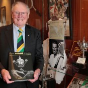Frank Sedgman poses with his biography at Kooyong Lawn Tennis Club; Fiona Hamilton
