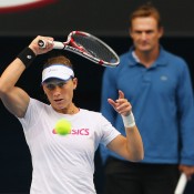 Sam Stosur plays a forehand as her coach David Taylor looks on during a practice session ahead of Australian Open 2013 at Melbourne Park; Getty Images