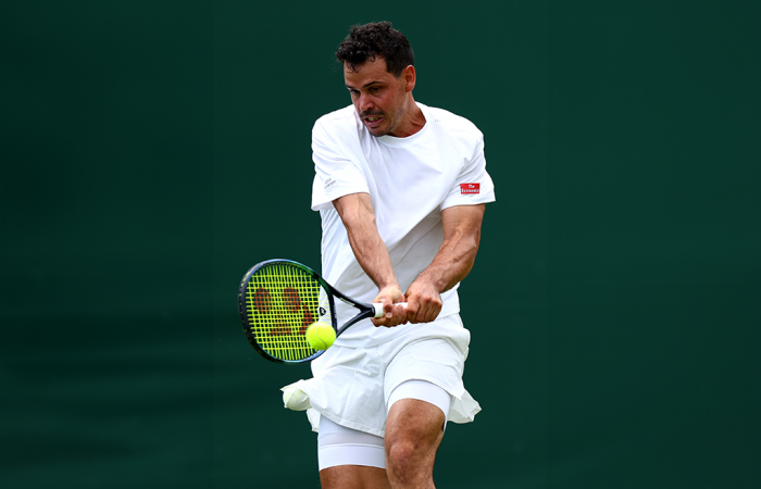 GettyImages-2160059185 LONDON, ENGLAND - JULY 01: Alex Bolt of Australia plays a backhand against Casper Ruud of Norway in the in the Gentlemen's Singles first round match during day one of The Championships Wimbledon 2024 at All England Lawn Tennis and Croquet Club on July 01, 2024 in London, England. (Photo by Francois Nel/Getty Images)